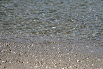 Gentle ripples of the ocean lapping on a pebbly beach