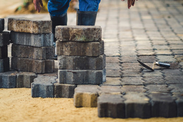 School janitor builds a brick pathway in school, Selective focus