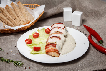 chicken breast with pear, cheese, bacon and mushrooms with cream sauce. concept healthy food.