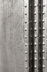 metal plate with rivets in grayscale mode