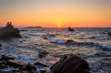 Sunset from Little Venice in 
Mykonos island with wavy sea and beautiful golden colors, Cyclades,...