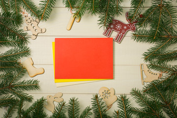 Fototapeta na wymiar Christmas tree frame branches, envelopes and christmas toys on wooden background with copy space. Horizontal template for design
