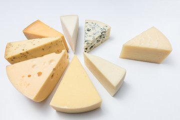 Different kinds of cheeses isolated on white background.