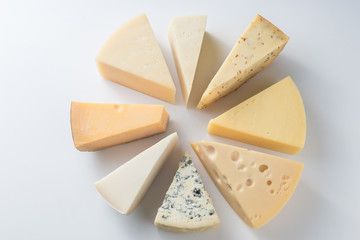Different kinds of cheeses isolated on white background.