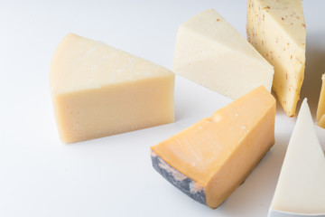 Different kinds of cheeses isolated on white background.