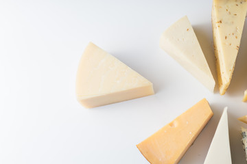 Different kinds of cheeses isolated on white background.