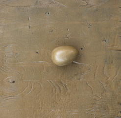 golden easter egg on a golden background