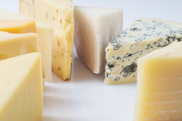 Different kinds of cheeses isolated on white background.