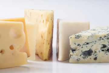 Different kinds of cheeses isolated on white background.