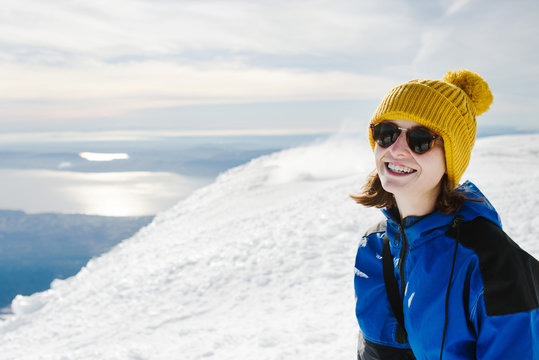 Portrait of a woman on the summit of a snow covered mountain