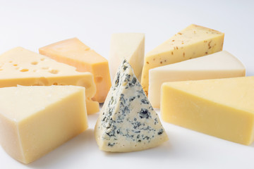 Different kinds of cheeses isolated on white background.