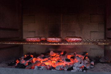 Meat burgers roasting on barbecue grill