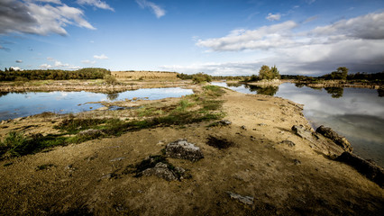 Sandy hills. Lake in the Sandy canyon. Warm colors background. Yellow sandstone textured mountain,...