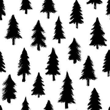 Seamless pattern with hand-drawn pine trees isolated on white background. Christmas forest wallpaper. Doodle style grunge shapes.