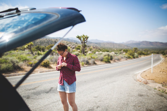 A young woman hiking between cacti in the California desert