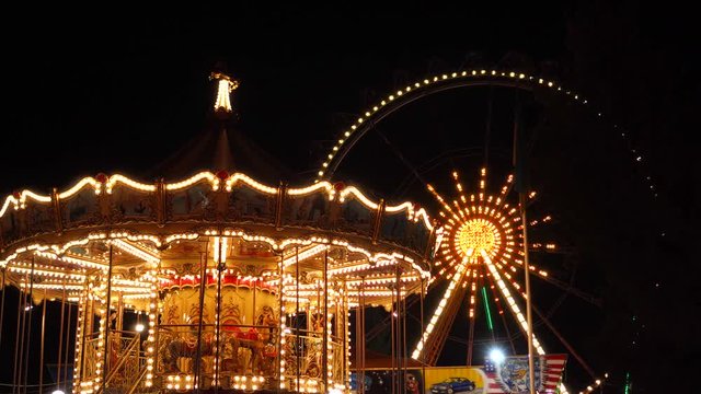 Incredible attraction roller coaster in funfair amusement park in flashing lights night illumination on dark background