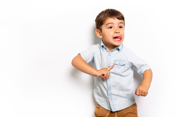 Boy having fun on studio grey background