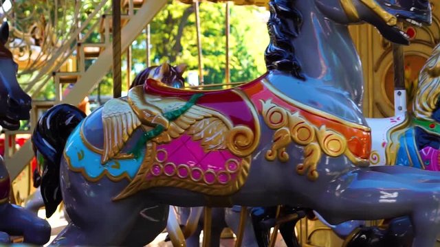 Retro vintage circus carousel horse merry go round kids attraction animal ride spinning at fun carnival in close up shot
