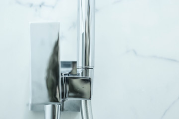  metal faucet bidet in the toilet.