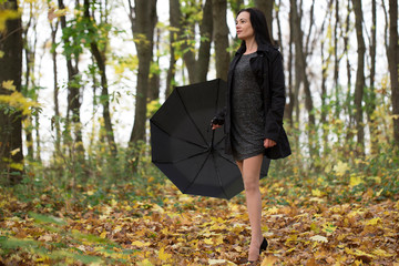 girl with umbrella. bad weather. walk in the autumn. a walk in the rain the Park. the girl with...