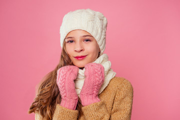 Portrait of young pretty smiling perfect skin and gray-blue eyes teenager girl in cold weather dressed in color clothes and warm white hat. Young happy woman autumn winter clothes seasonal sale