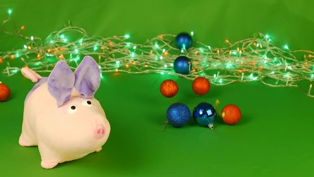 piggy or mumps and falling Christmas decorations toys taws, New year 2019 on green Chroma key