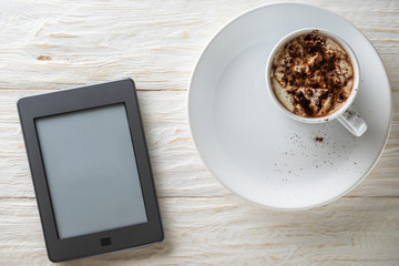Morning breakfast with a cup of cocoa and an e-book