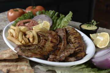 steak with potatoes in plate in restaurant