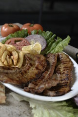 steak with potatoes in plate in restaurant