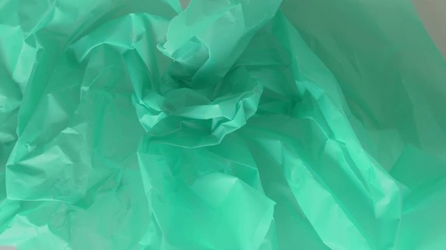 Green paper straightens and takes on a different shape