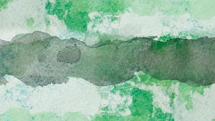 green watercolor stripe, on paper covered with paint, spilled watercolor droplets texture watercolor paper. for decoration of a card with a place for text green dark line