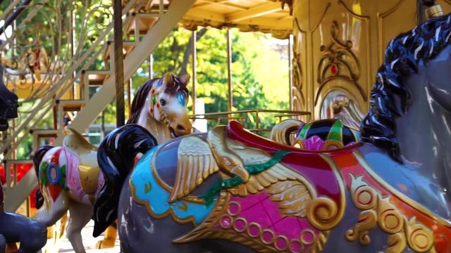 Marvelous close up view on vintage circus carousel retro merry go round horse ride kids attraction spinning at funfair