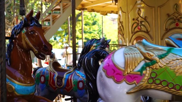 Wonderful retro circus carousel vintage merry go round horse ride attraction spinning at amusement park in close up shot