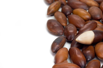 Brazilian Baru nut (castanha de baru) in half side of frame in white background