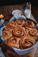 Homemade cinnamon rolls on wooden background