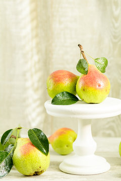 Many juicy beautiful amazing nice pears on light wooden background