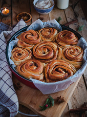 Homemade cinnamon rolls on wooden background