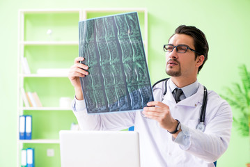Doctor radiologist looking at x-ray scan in hospital