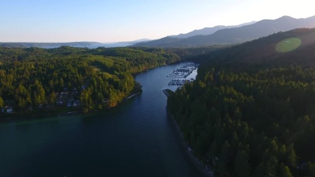 Beautiful harbor near Brinnon, Washington for boat mooring with vacation homes ling the shores. 
