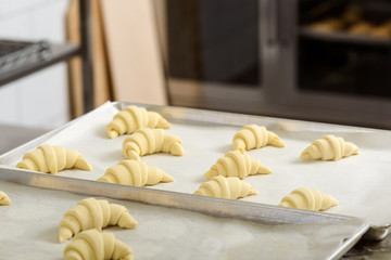 Raw crescent rolls on tray