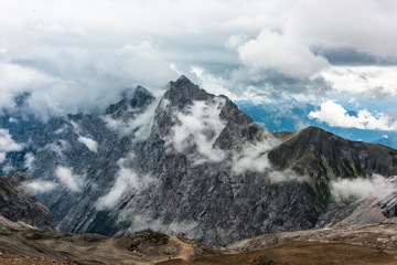 Fototapeta na wymiar View from Zugspitze mountain toward Austria. Summer cloudy shot.Altitude 2650 meters