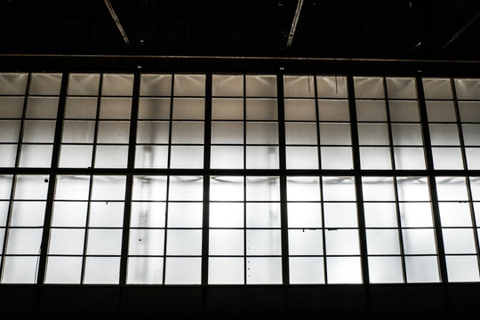 Sunlight shining throuh the windows of an old abandoned industrial warehouse building