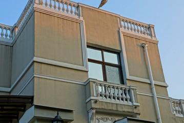 one open balcony on the wall of a large house