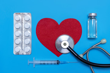 Medical, medicine stethoscope, syringe, injection and pills on blue background. Health care or...