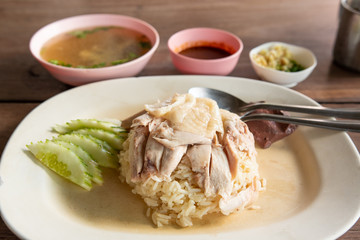 Hainanese chicken rice, steamed chicken and white rice.