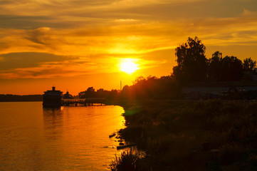 Fototapeta premium beautiful yellow and orange sunset on the river