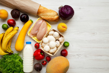 Set of various healthy food on white wooden table, top view. Cooking food background. Healthy food concept. Copy space.
