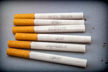 Several cigarettes with words embedded from diseases caused by smoking