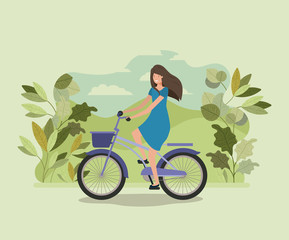 young woman in bicycle on park