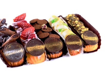 Delicious dessert on a white background. A fresh and tasty eclair is isolated on a white background, with beautiful decor.